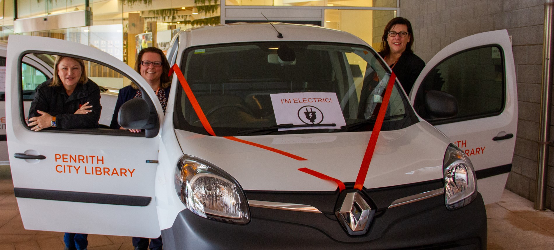 Image showing (L-R) Penrith Mayor Tricia Hitchen, Library Services Manager Sarah Dean, and Council’s Director Community and People, Sandy Davies beside Penrith City Council's second electric vehicle..