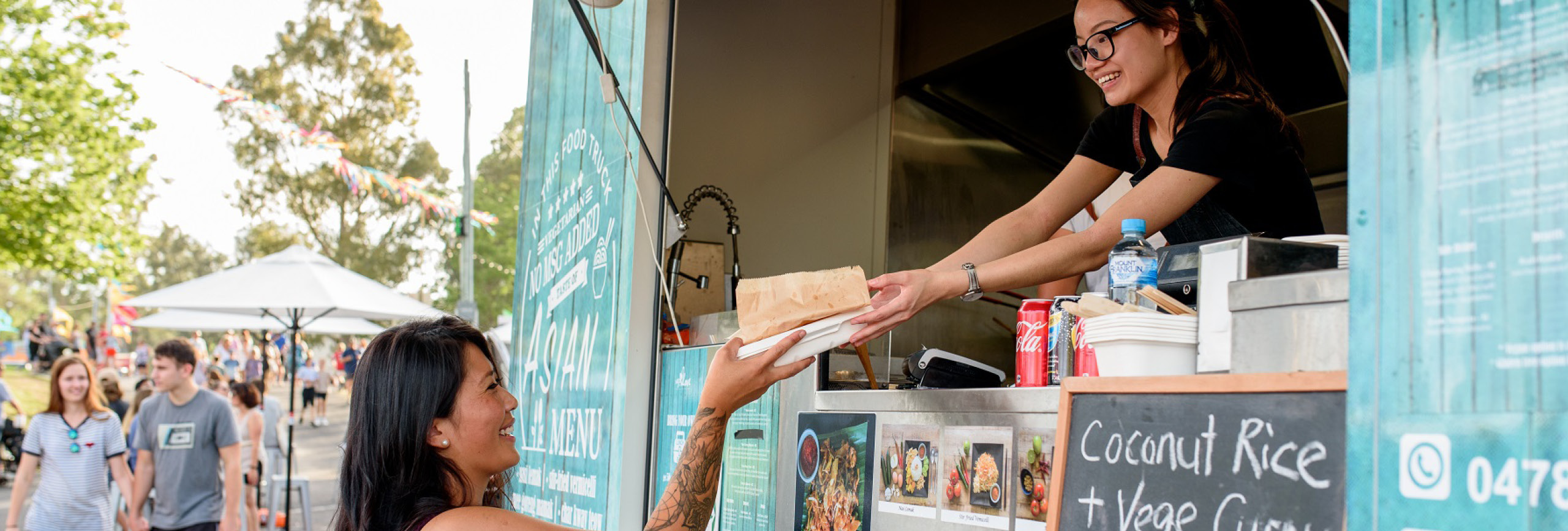 Woman receiving food from a food truck