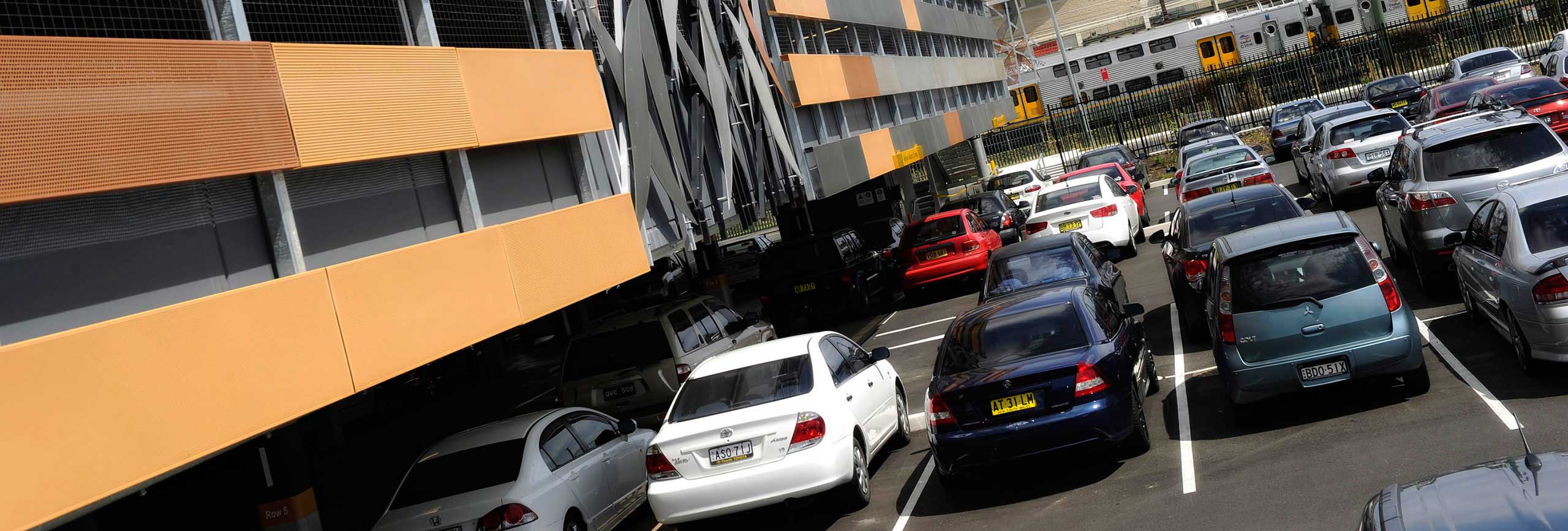 Cars parked near the rail line