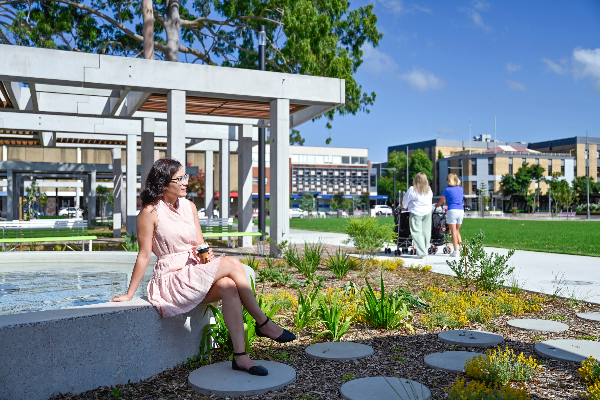 woman sitting on bench in park