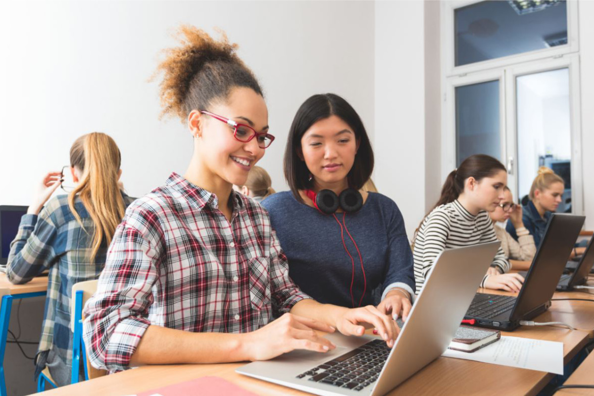 two women looking at laptop