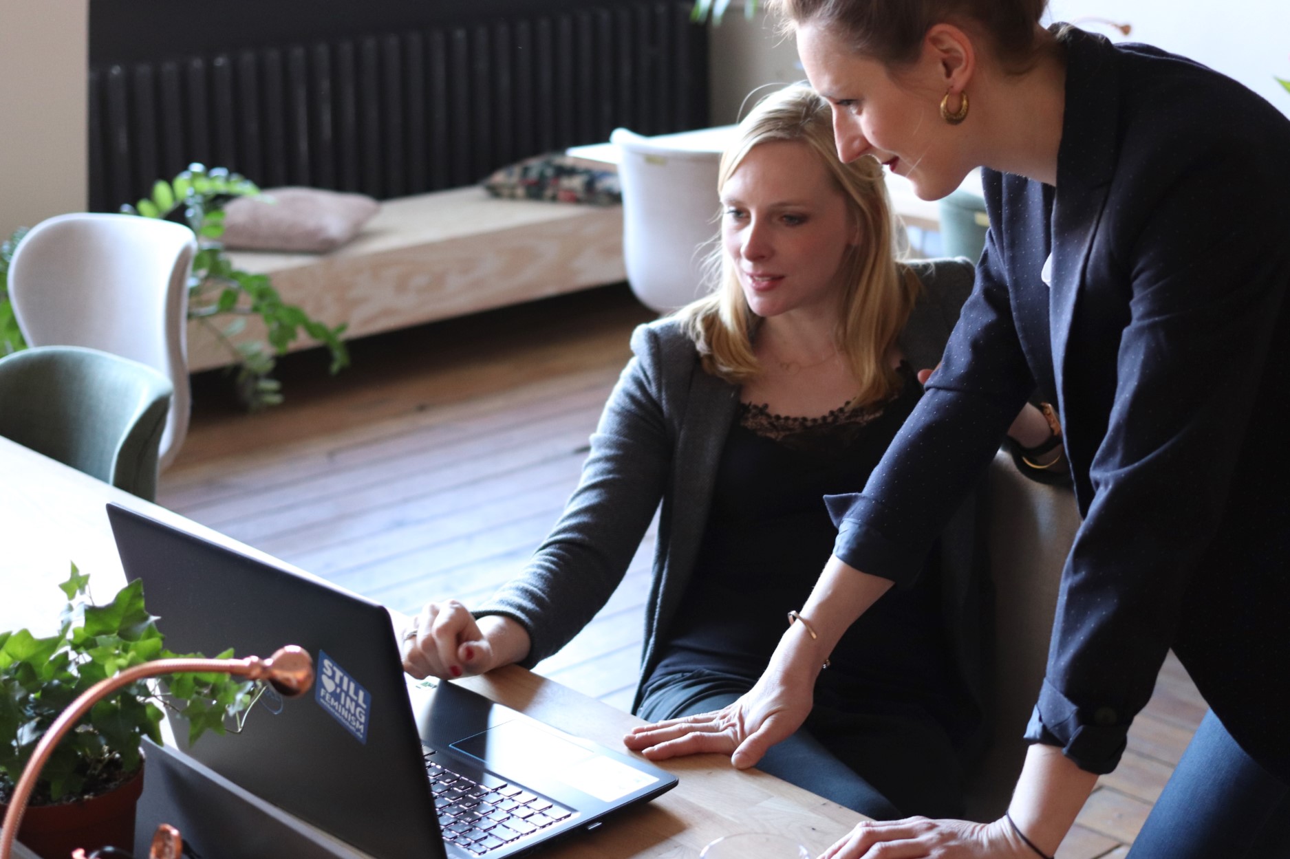 two women looking at a laptop