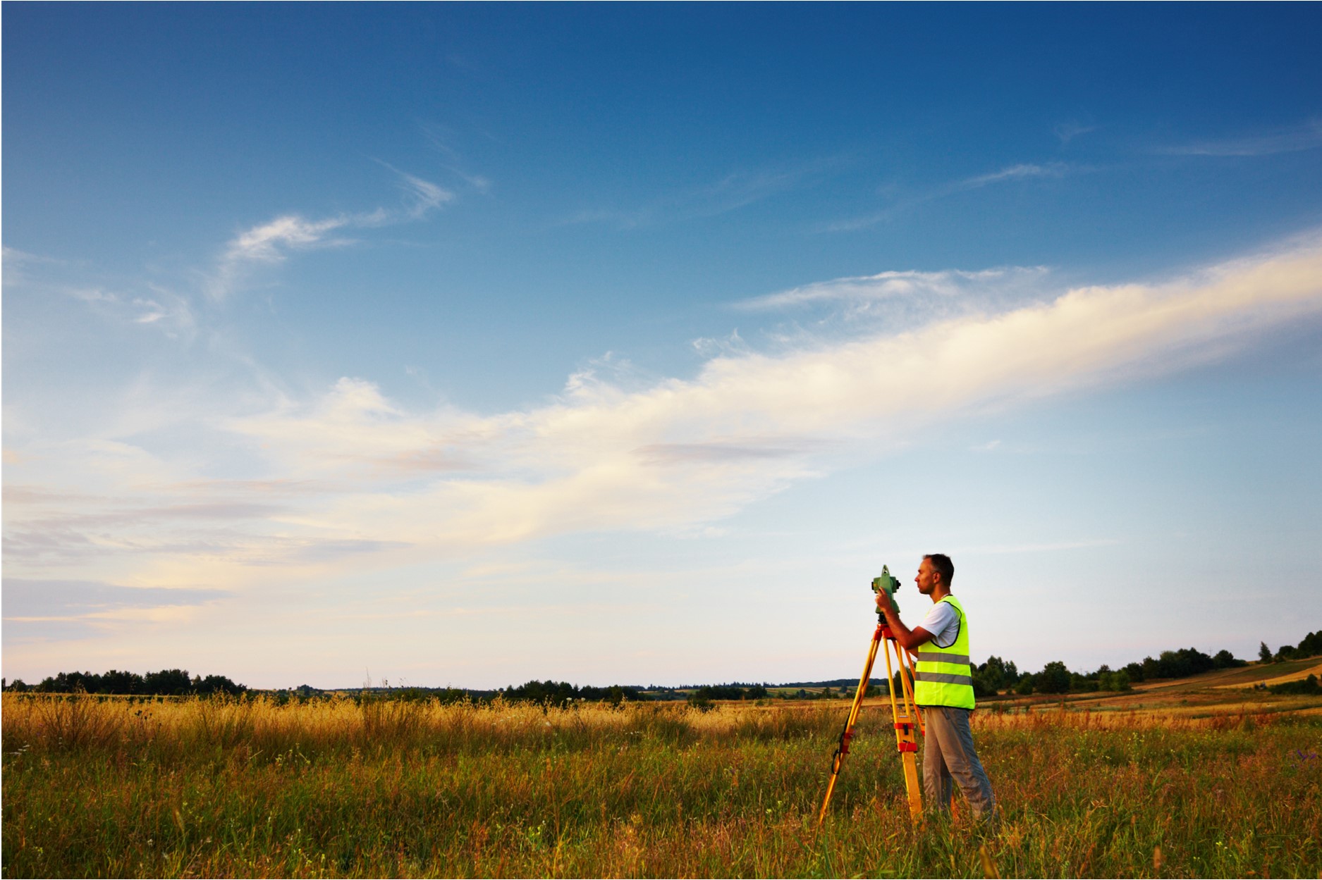 surveyor standing in open field