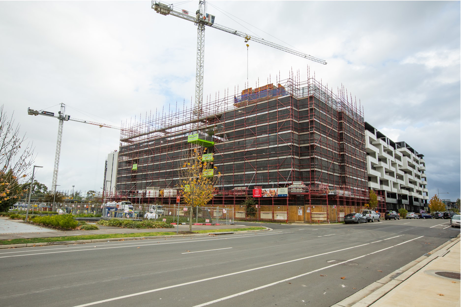 construction site with cranes and scaffolding