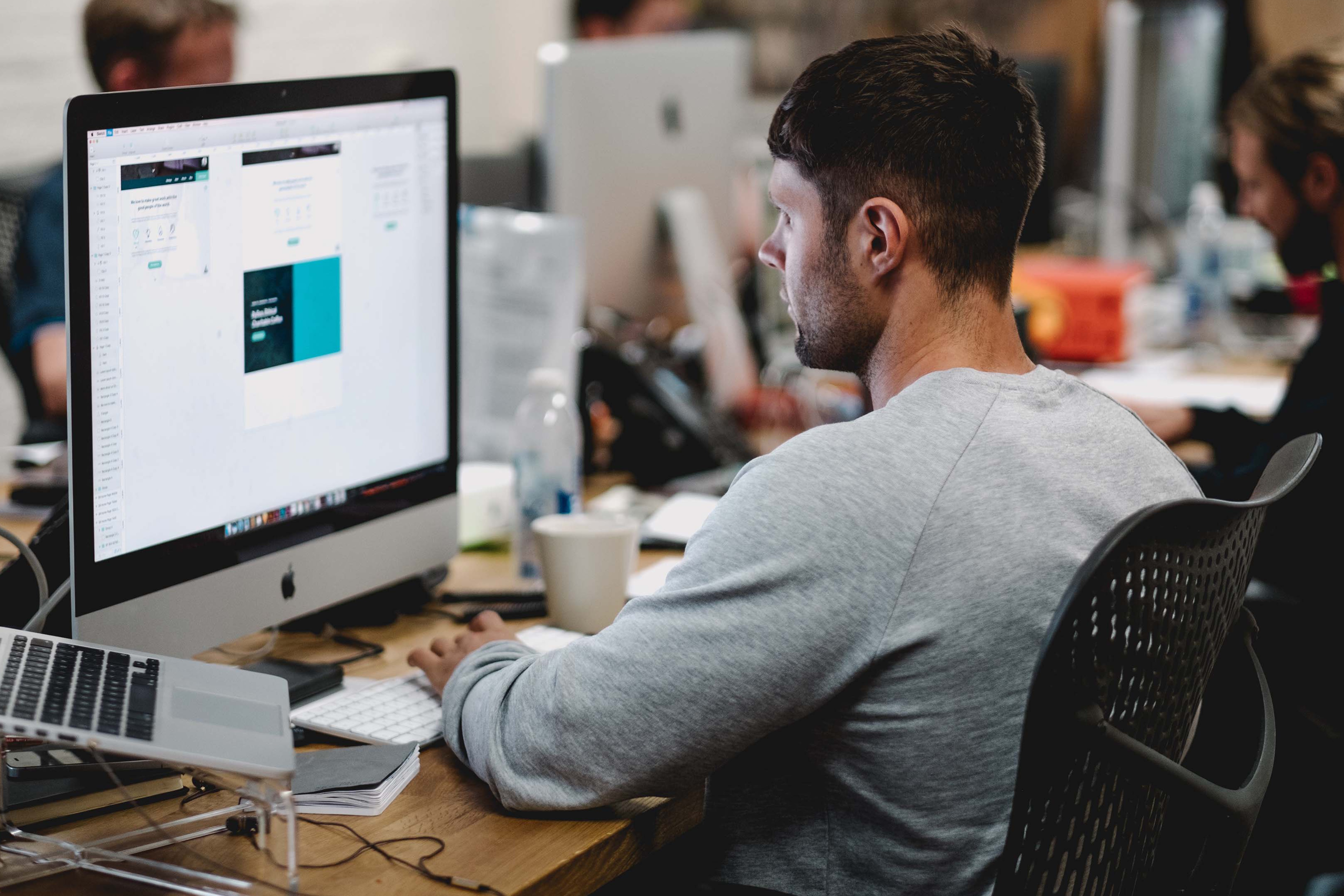 man at desk looking at computer