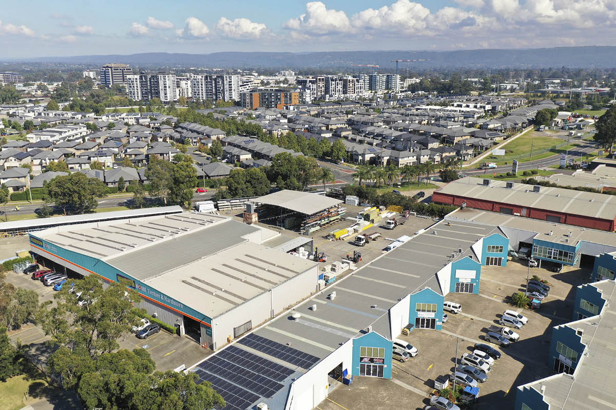 aerial view of industrial units with city in distance