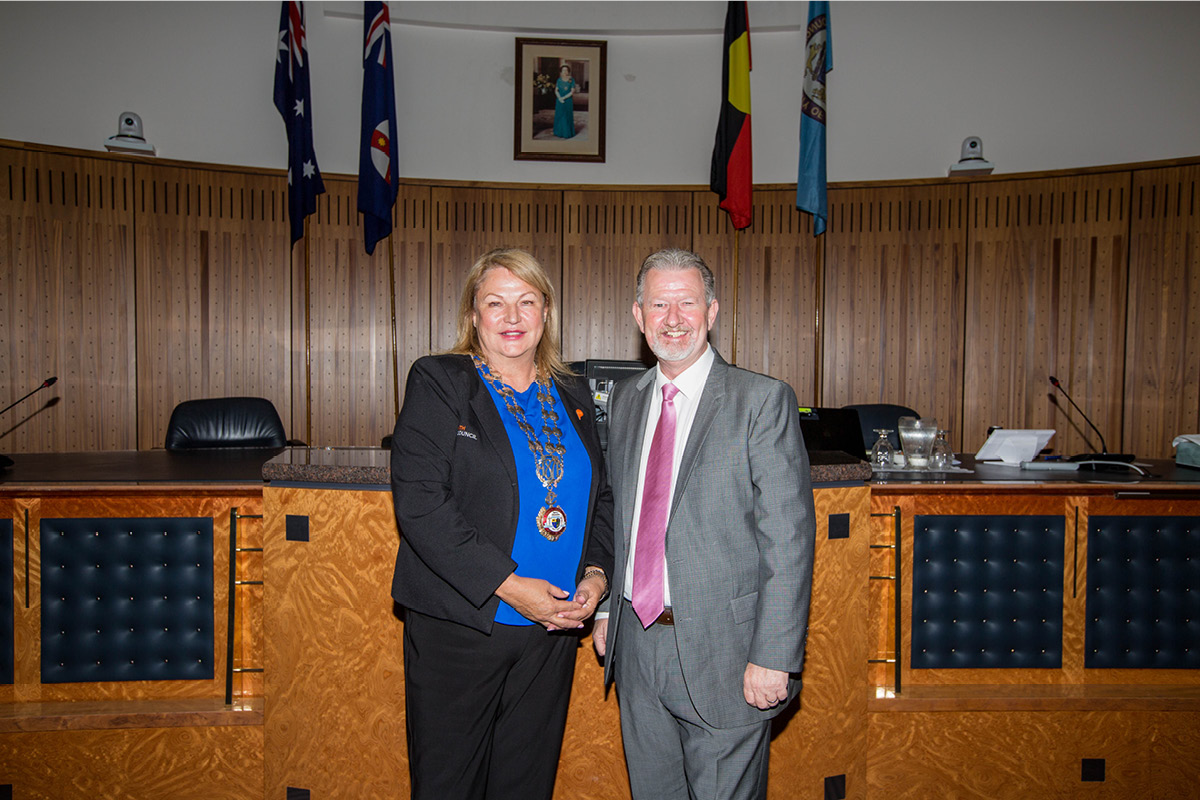 woman and man standing inside council chambers