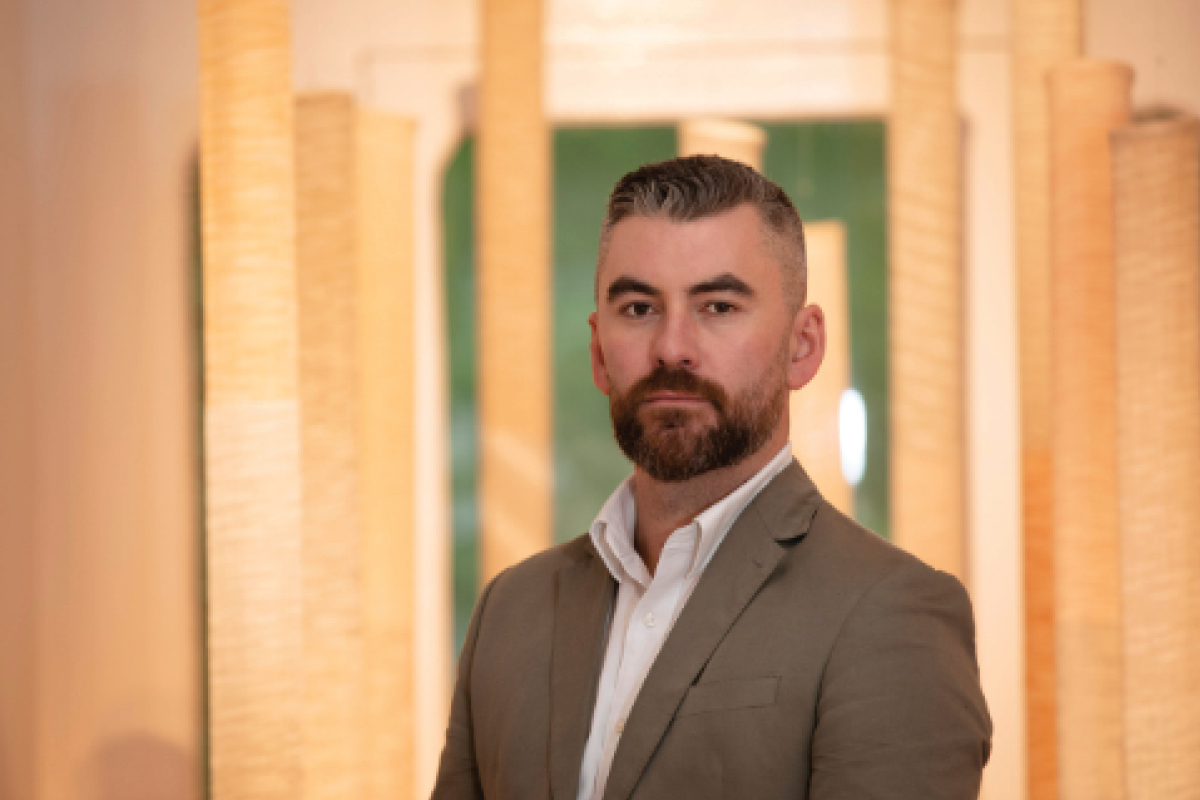 man standing in hallway looking to camera