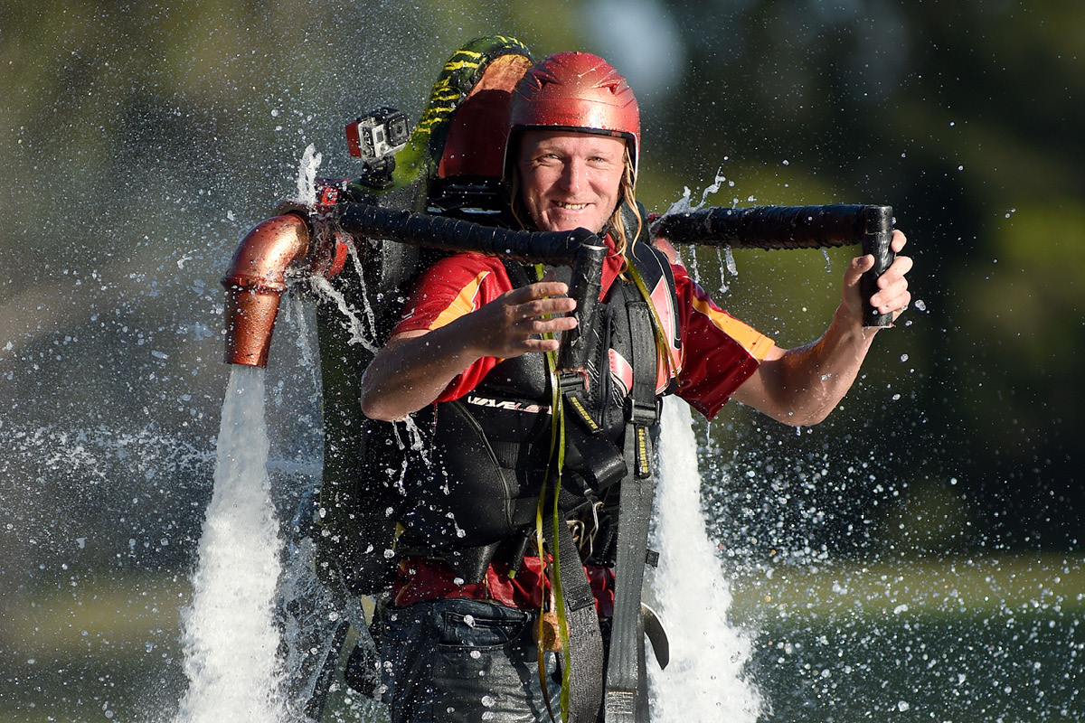 man operating jet pack over water