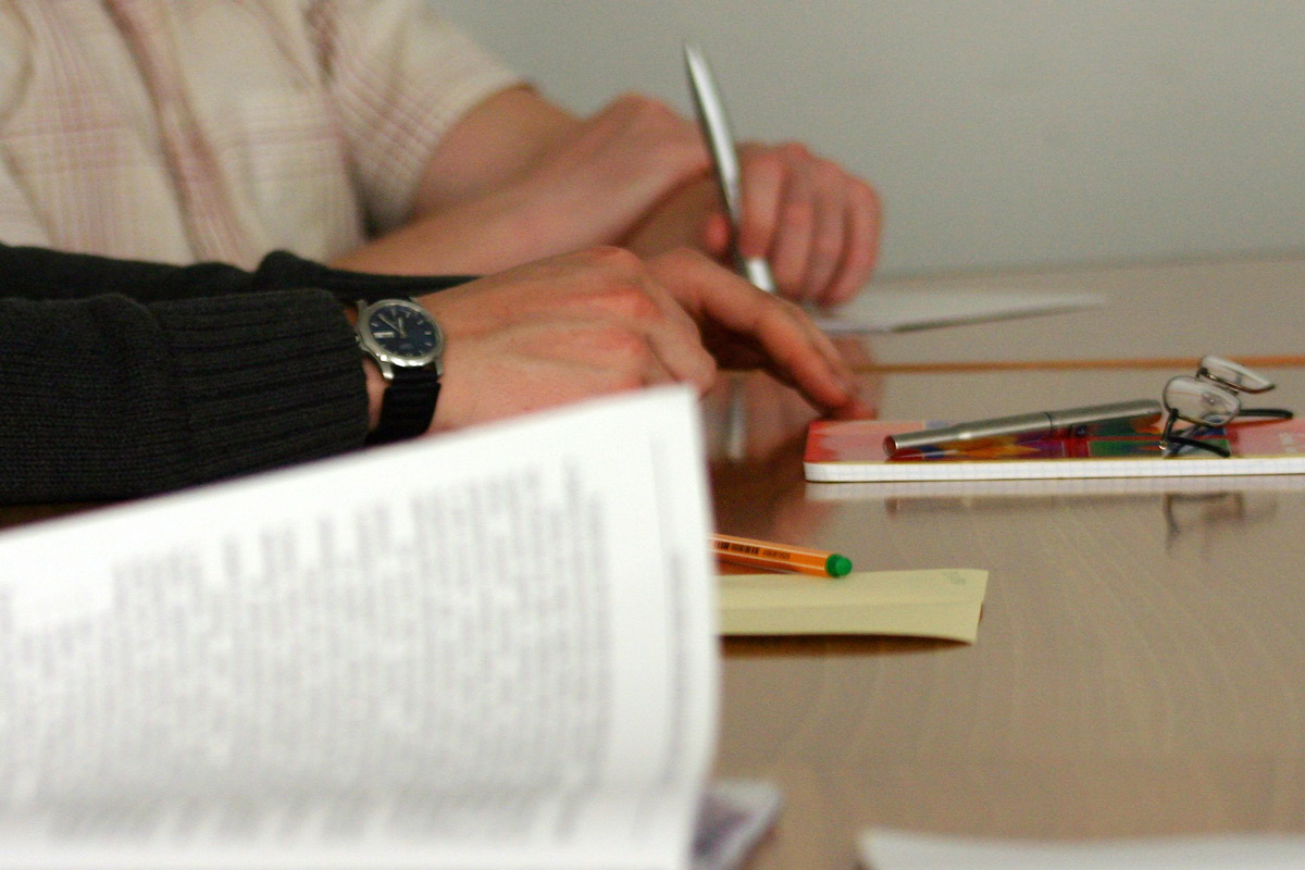 Hands filling in documents