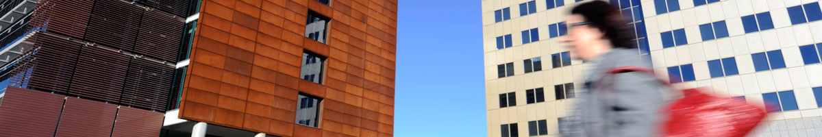 Lady walking with buildings in the background