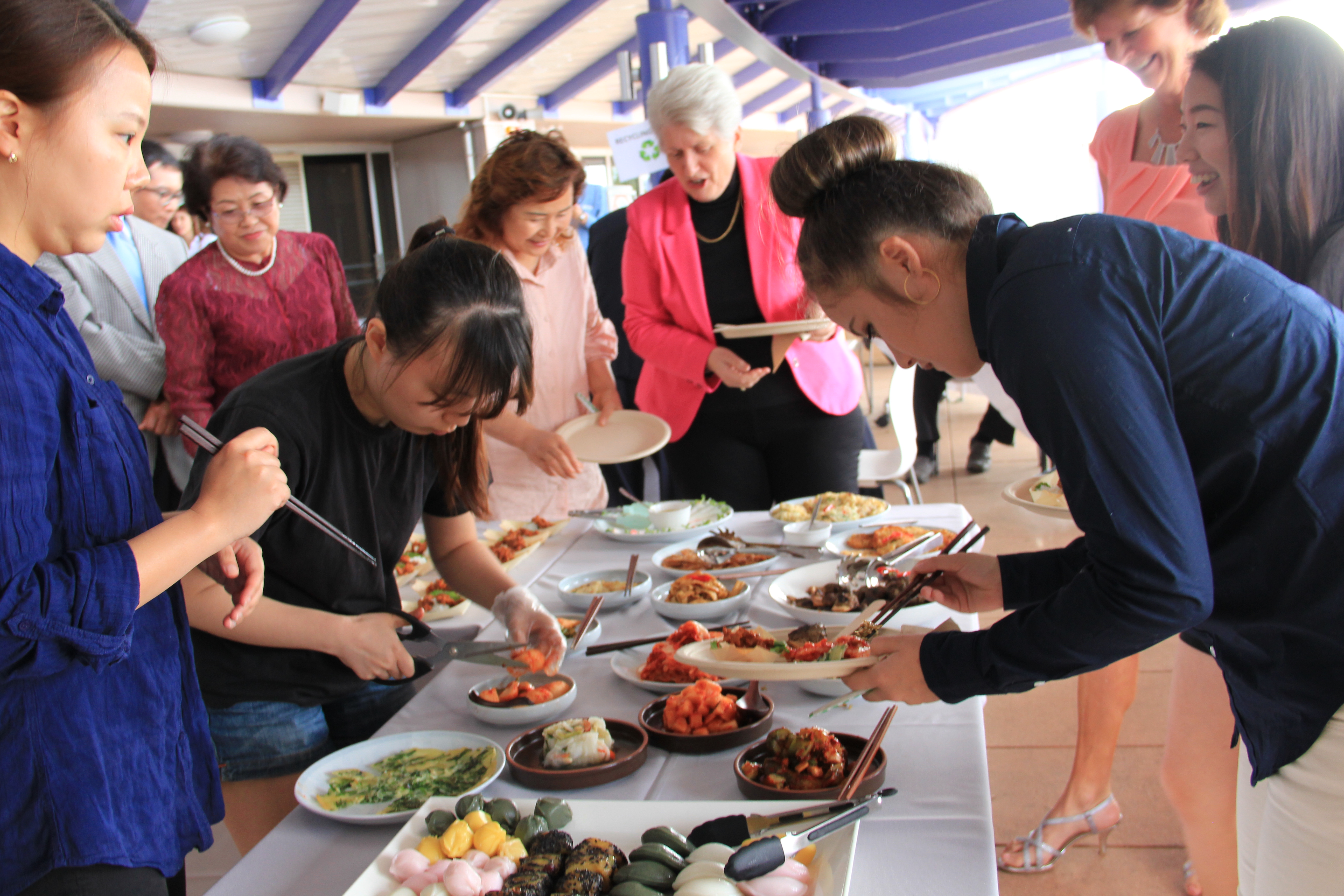 Image showing community members enjoying traditional Korean food 