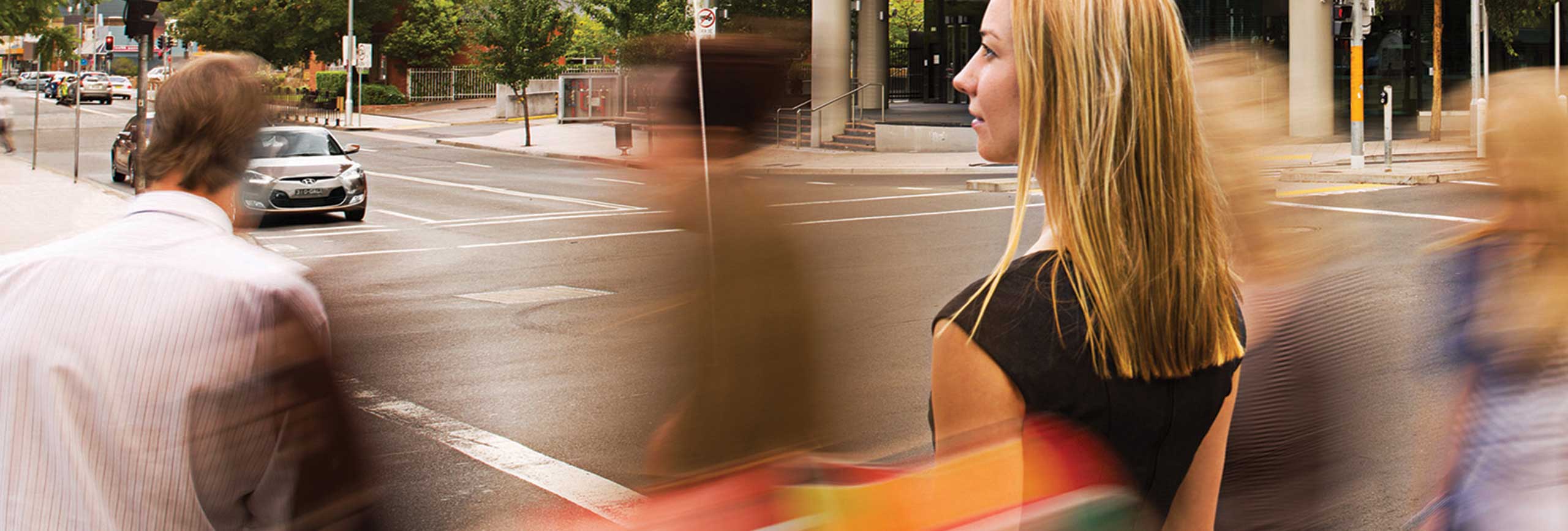 People waiting to cross the road at traffic lights