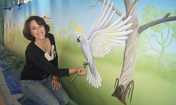 woman painting city park hoarding