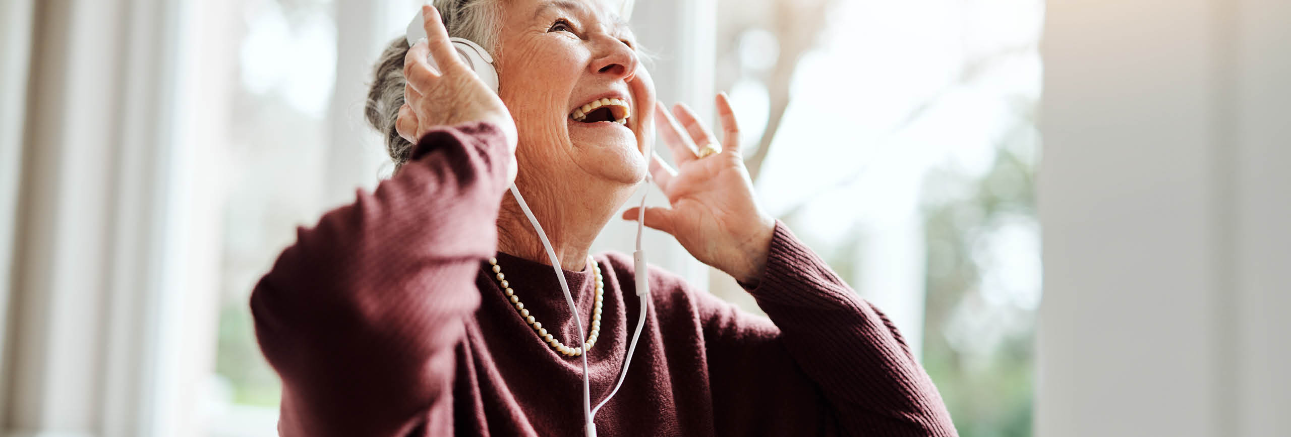 A woman with a hearing device.