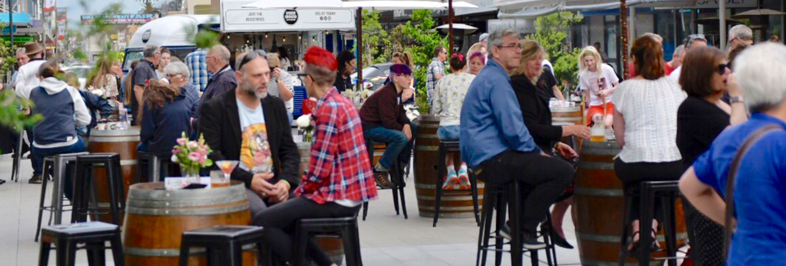 People sitting outside enjoying food and drinks