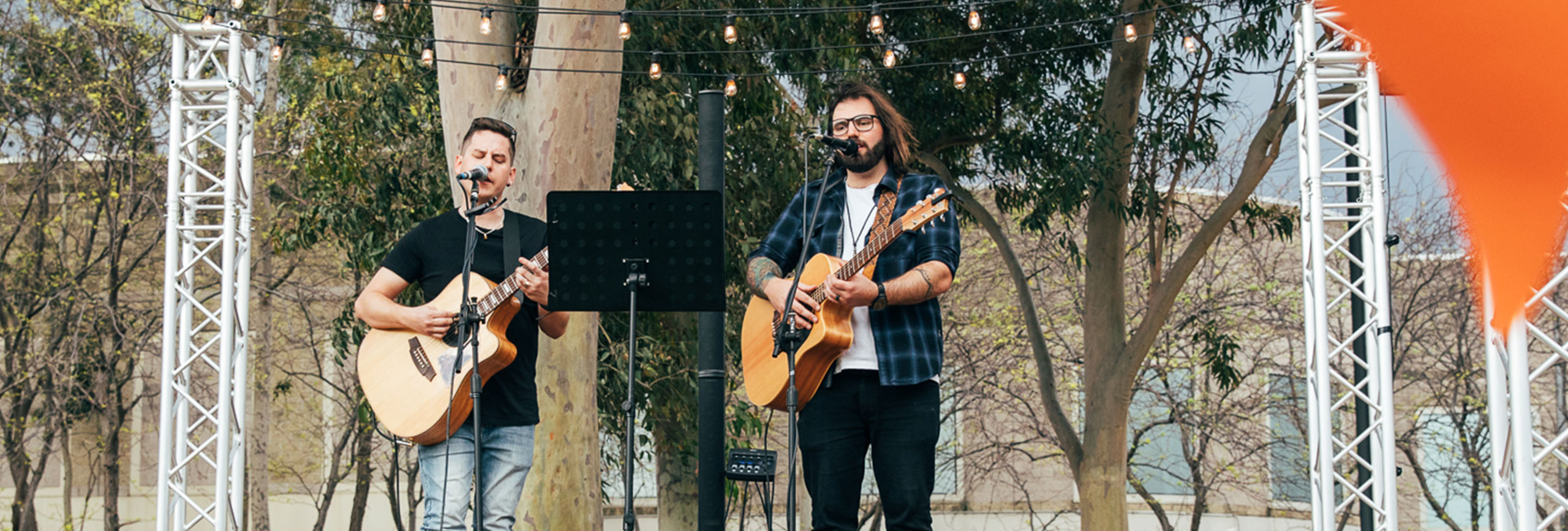 Two men playing guitars and singing